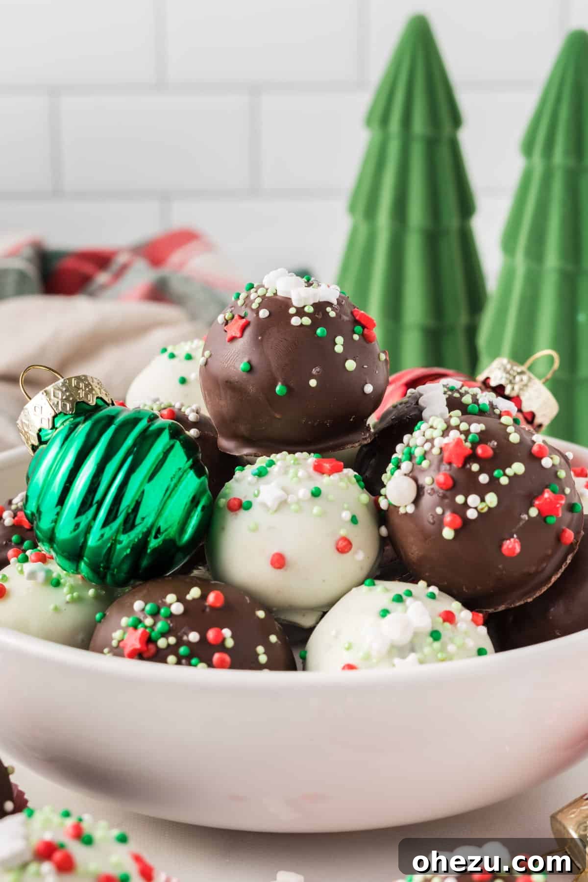 Decadent Holiday Oreo Treats 3 A bowl overflowing with festive Christmas Oreo balls, surrounded by holiday decorations