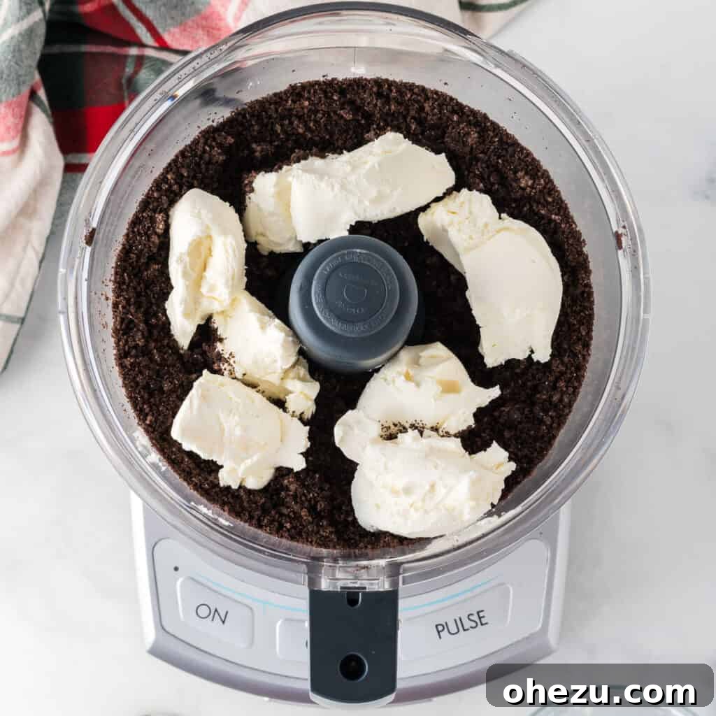 Decadent Holiday Oreo Treats 7 Adding softened cream cheese to the crushed Oreos in a food processor