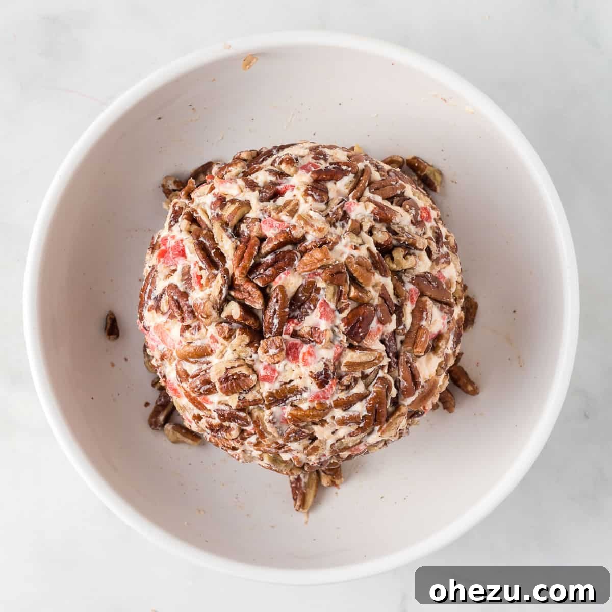 finished pimento cheese ball, perfectly rolled in pecans and ready for serving