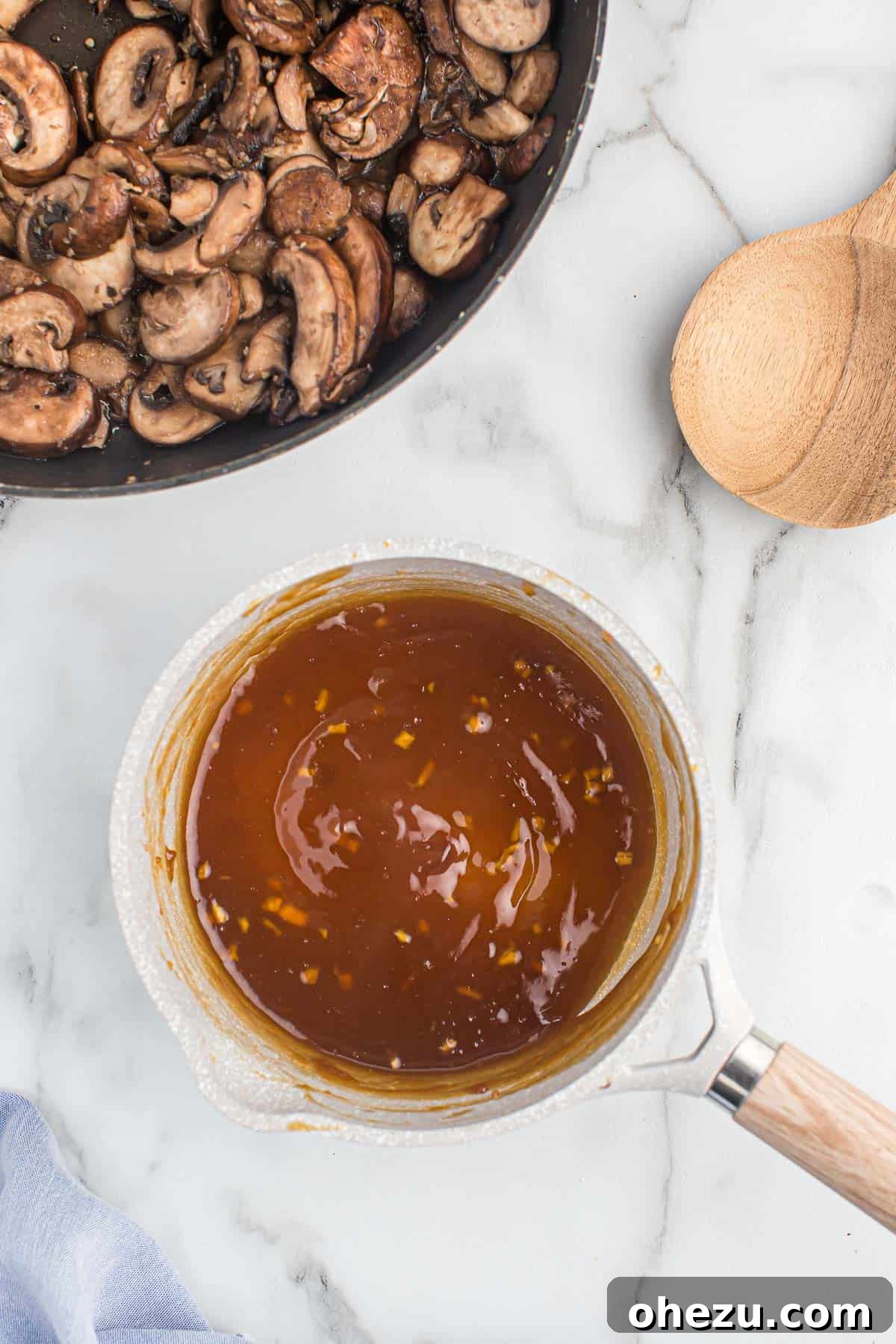 A close-up view of freshly made, glossy homemade teriyaki sauce simmering in a saucepan, vibrant and aromatic.