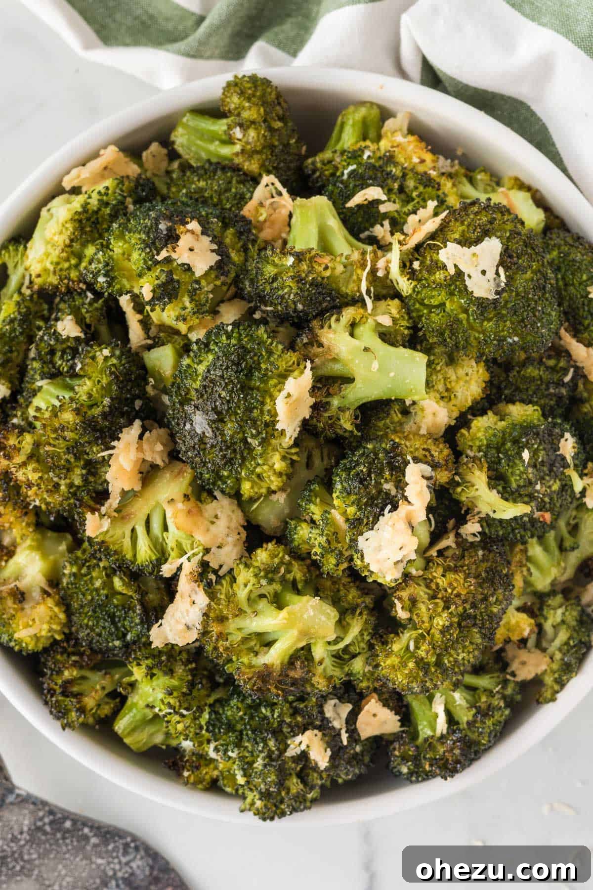 Crispy Parmesan Roasted Broccoli 12 A large rustic bowl filled to the brim with perfectly roasted broccoli with golden-brown parmesan cheese