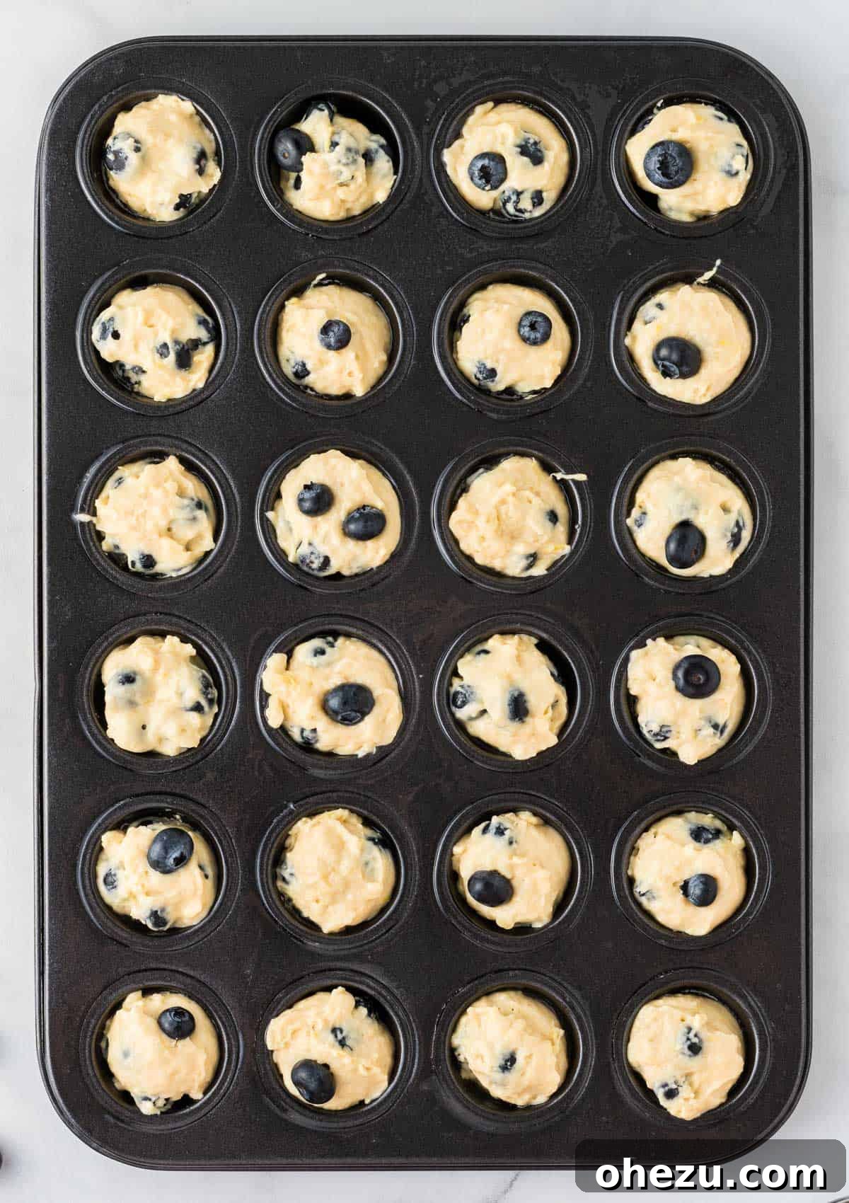 Blueberry Poppers 15 Mini muffins baking in the oven, showing the golden-brown tops forming.