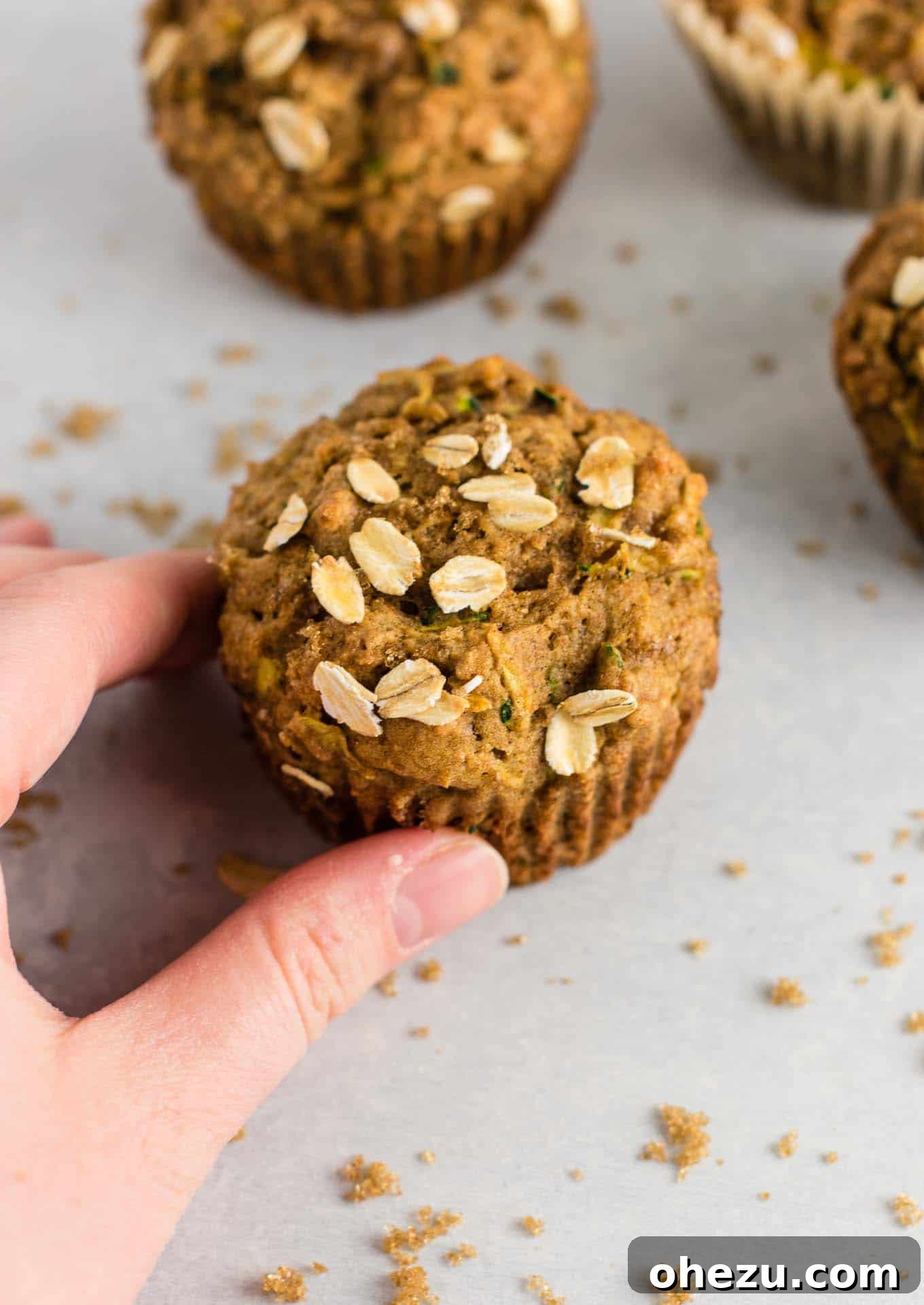 Close-up of fluffy healthy zucchini muffins, showcasing their moist texture and golden-brown tops.