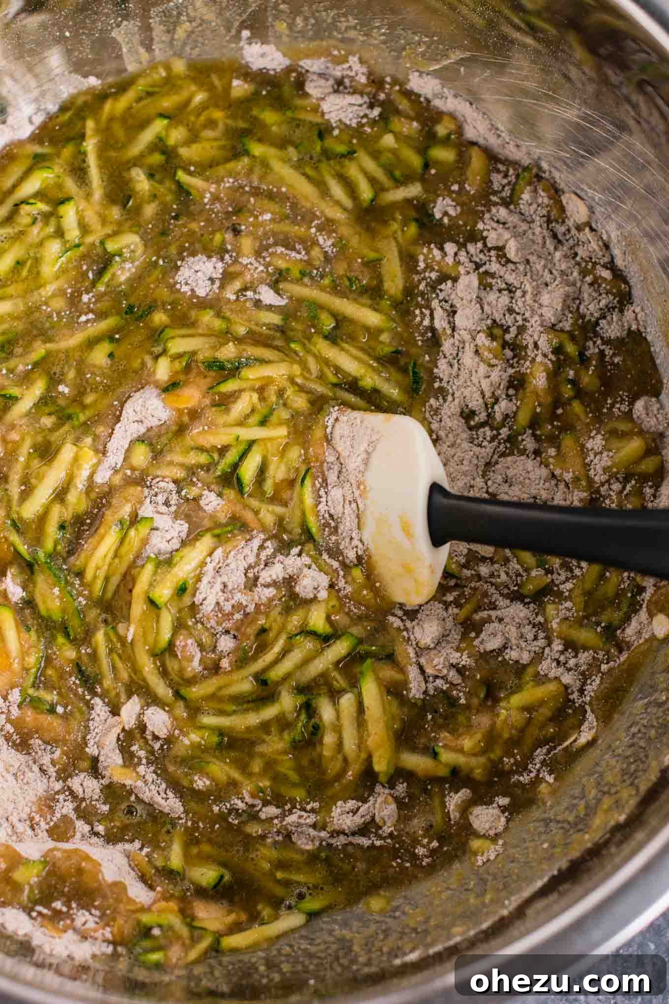 A cooling rack filled with healthy zucchini bread muffins, showcasing a bountiful batch.