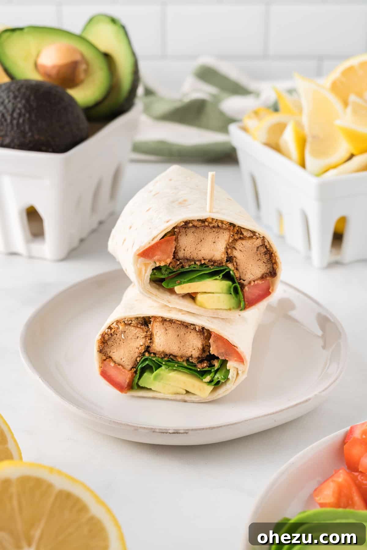 Vibrant Tofu Wraps 16 Several perfectly rolled tofu wraps stacked neatly on a white plate, showcasing a ready-to-eat vegetarian lunch.
