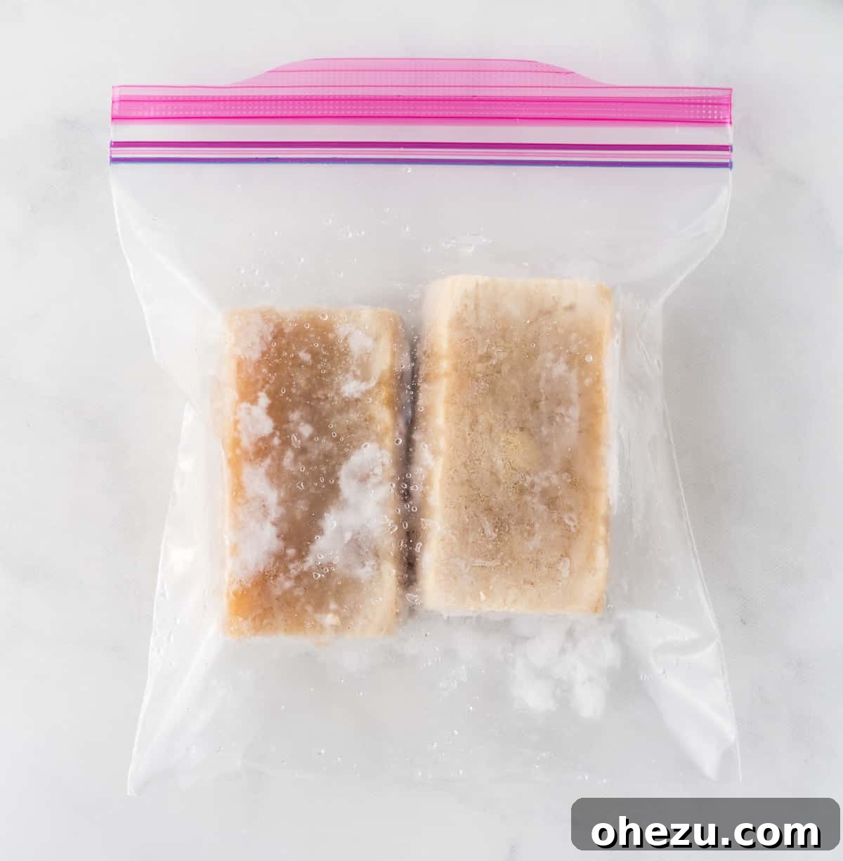Vibrant Tofu Wraps 5 A frozen block of tofu in a clear freezer bag, ready for thawing and pressing.
