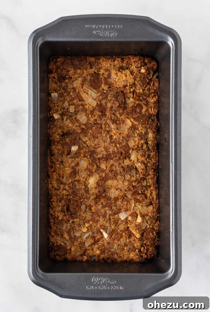 Meatless Meatloaf Marvel 11 Another perspective of the vegetarian meatloaf firmly packed into a loaf pan, showing its readiness for the initial baking phase.