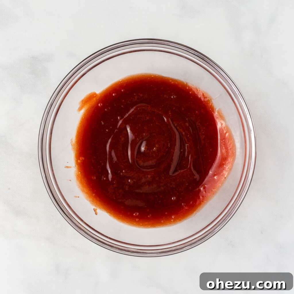 Meatless Meatloaf Marvel 13 The finished brown sugar and ketchup glaze in a small bowl, perfectly smooth and ready to be spread over the partially baked vegetarian meatloaf for a delicious topping.