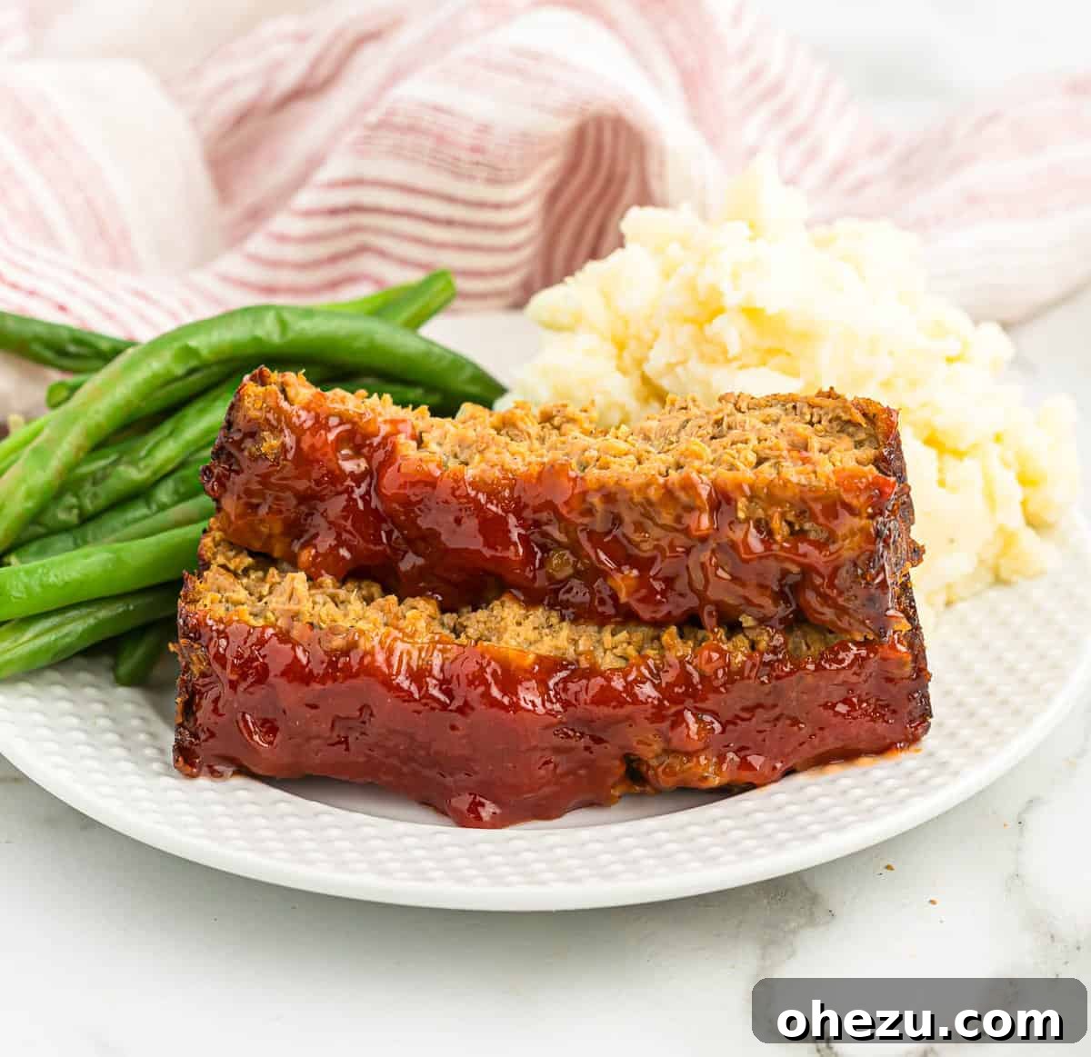 Meatless Meatloaf Marvel 18 A beautifully presented meal of vegetarian meatloaf, green beans, and mashed potatoes, highlighting a complete and appetizing plant-based dinner.
