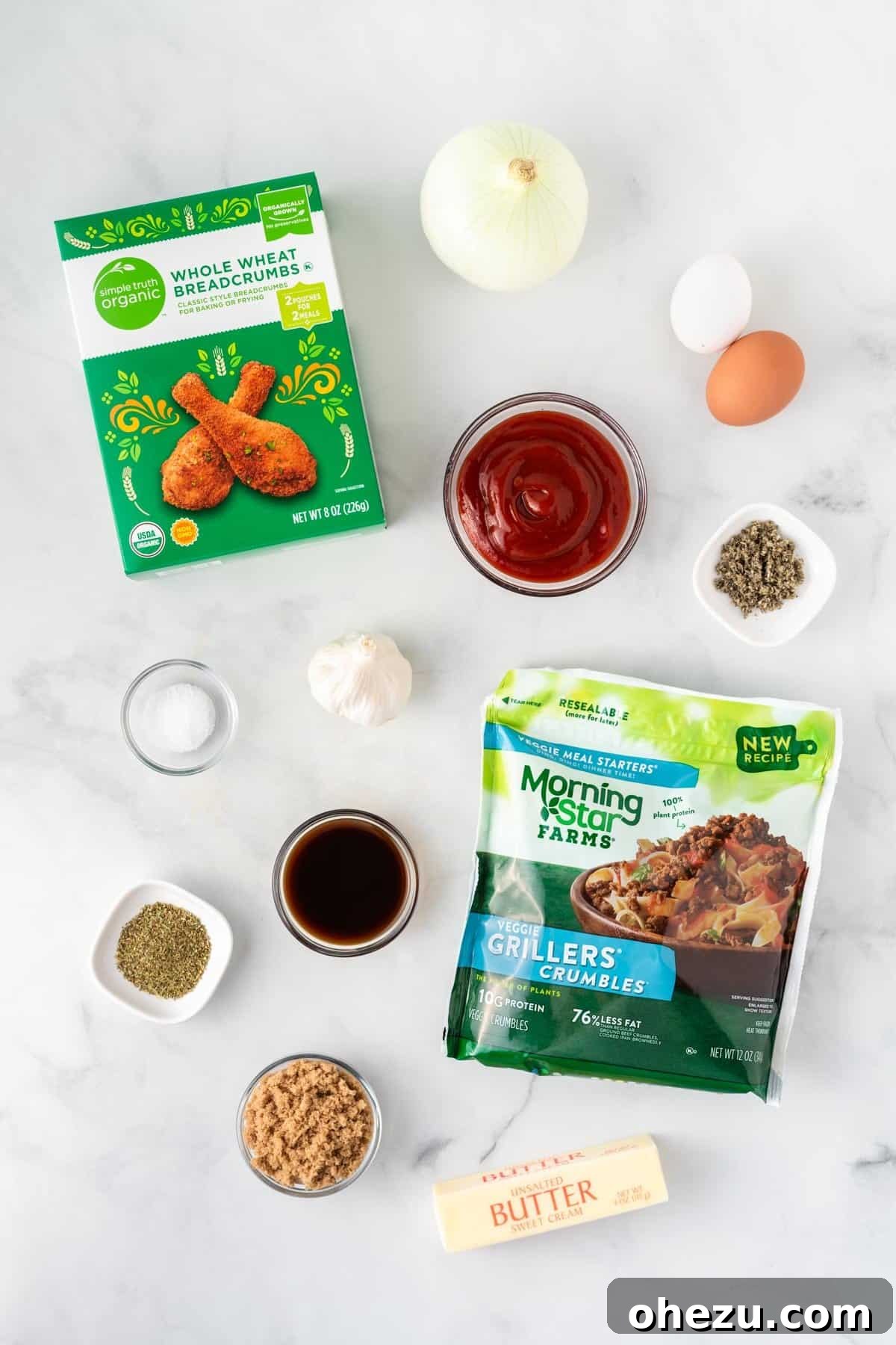 Meatless Meatloaf Marvel 5 A vibrant selection of fresh ingredients laid out on a clean counter, including meatless crumbles, eggs, breadcrumbs, garlic, onion, and various seasonings, ready to be transformed into a delicious vegetarian meatloaf.