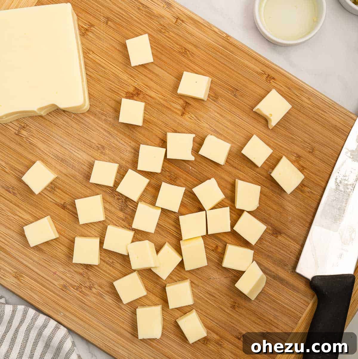 Fresh White Cheese 3 cutting american cheese into blocks on a cutting board