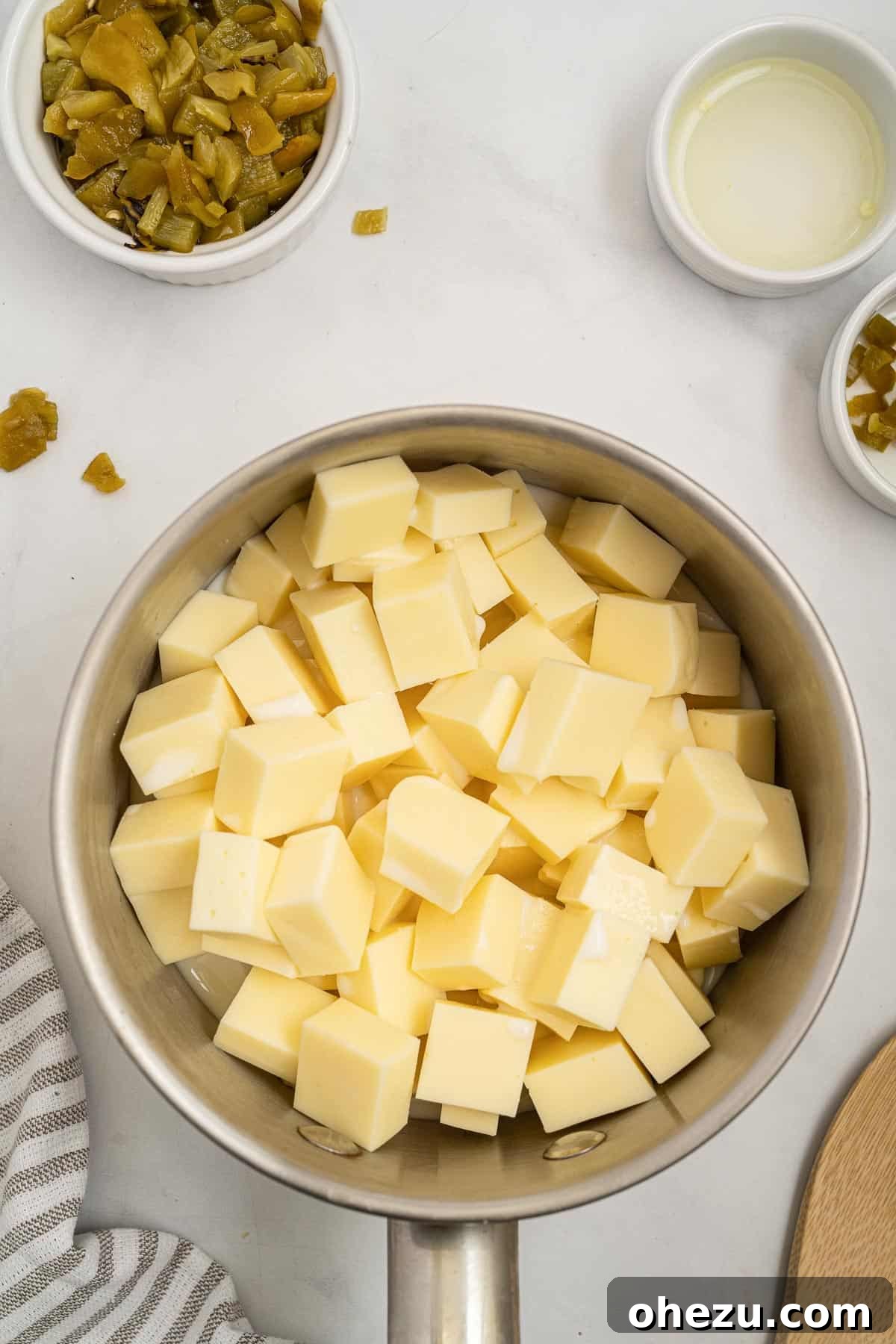 Fresh White Cheese 4 american cheese chunks in a sauce pan