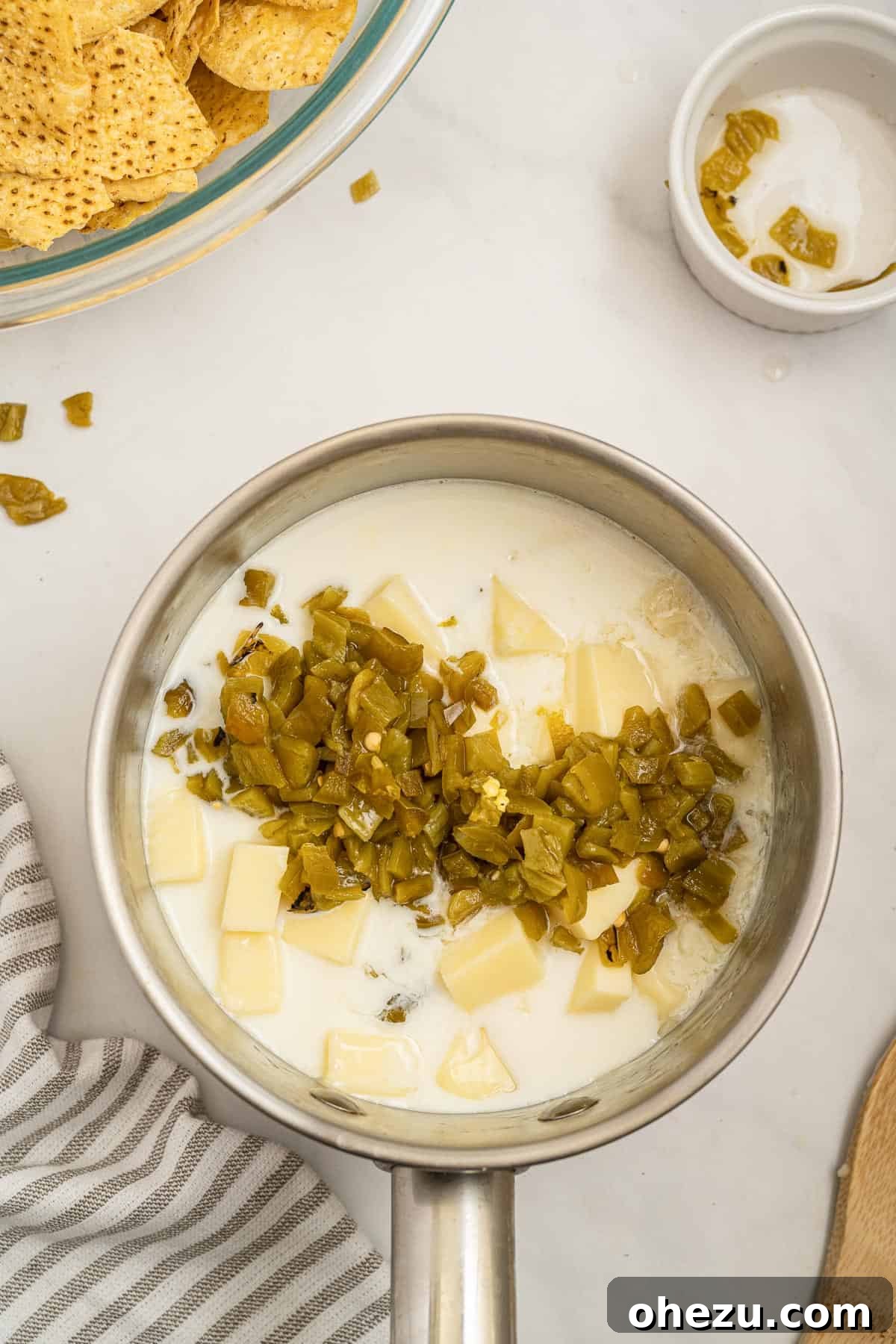 Fresh White Cheese 5 adding milk and jalapeno peppers to the american cheese