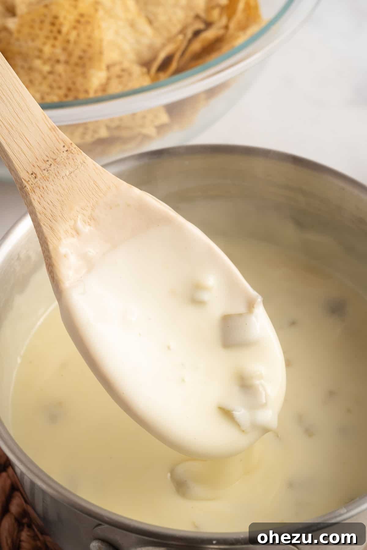 Fresh White Cheese 6 wooden spoon stirring queso blanco