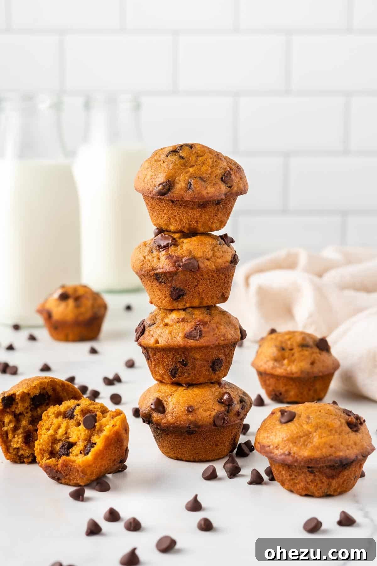 A stack of perfectly baked mini pumpkin muffins showcasing their inviting texture and golden tops.