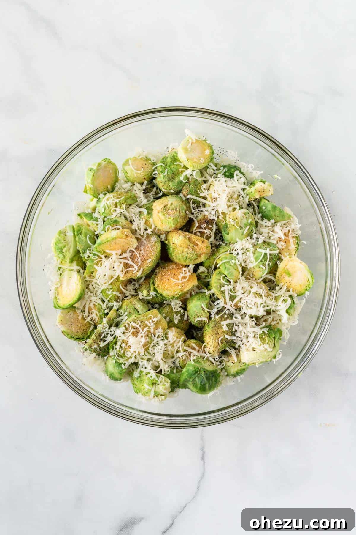 Perfectly Crispy Air Fryer Brussels Sprouts 6 Adding olive oil and spices to Brussels sprouts in a bowl