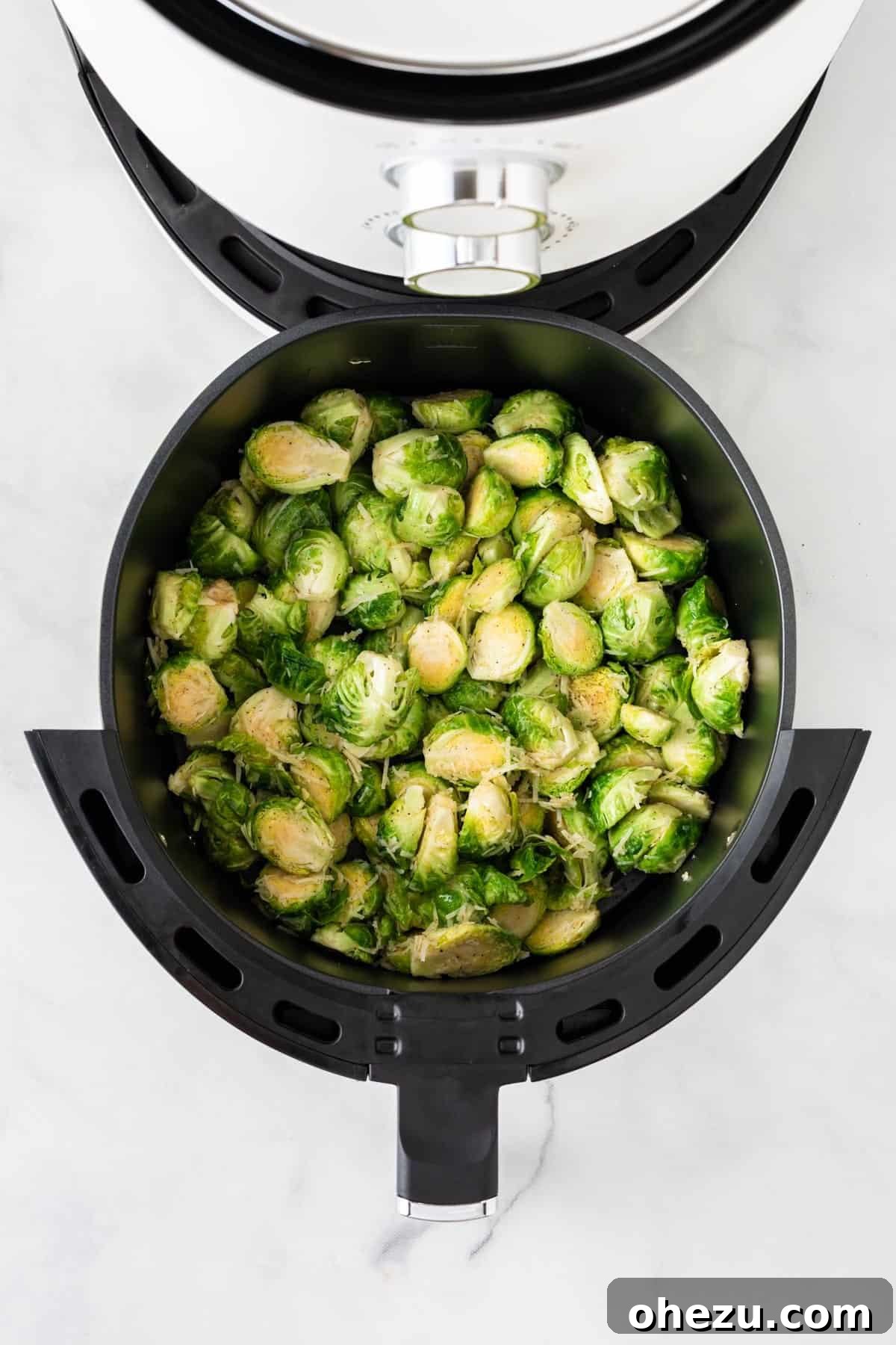 Perfectly Crispy Air Fryer Brussels Sprouts 7 Placing seasoned Brussels sprouts into the air fryer basket in a single layer