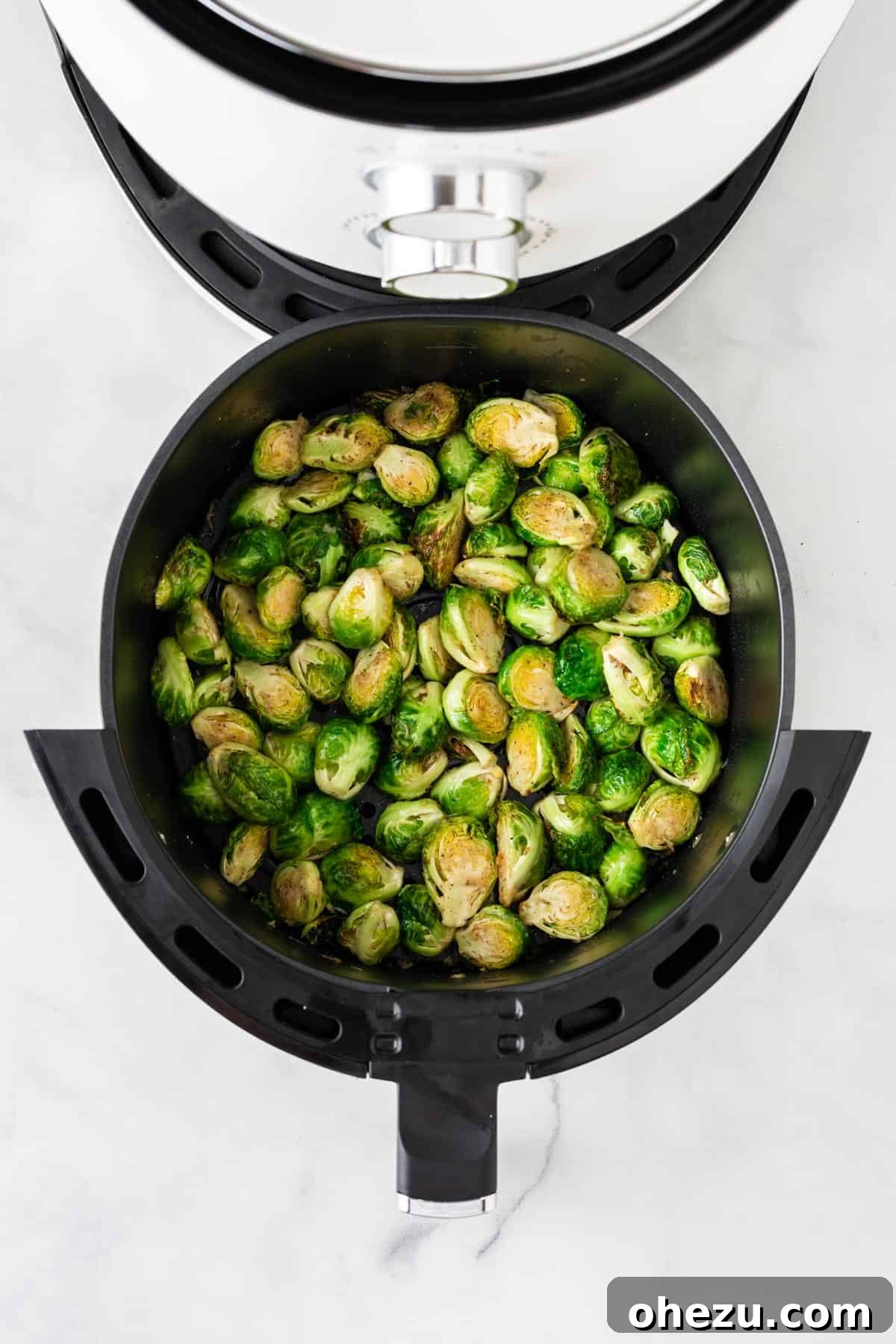 Perfectly Crispy Air Fryer Brussels Sprouts 8 Brussels sprouts cooking and crisping in the air fryer