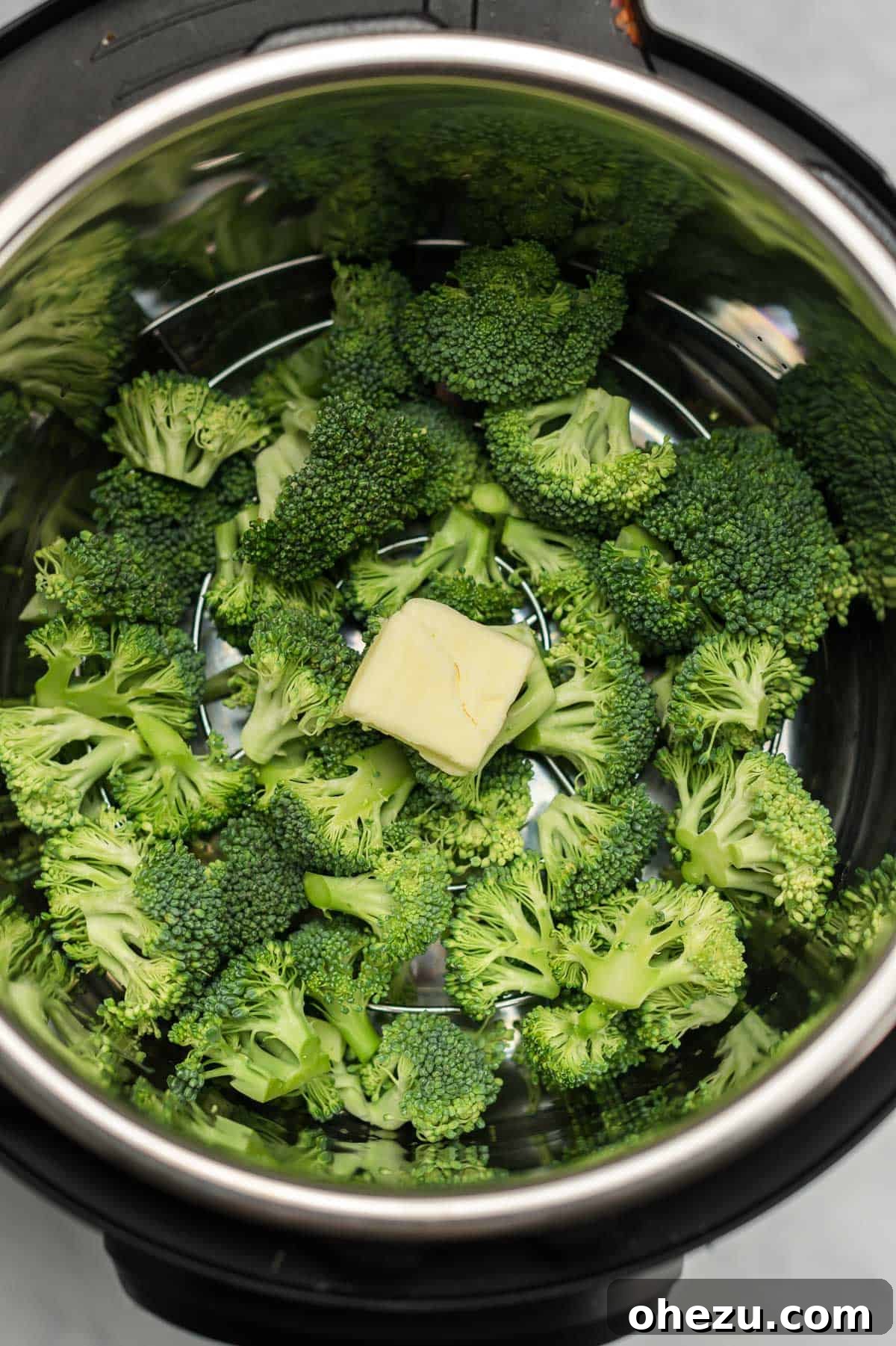 Effortless Instant Pot Broccoli 4 A pat of butter placed in the center of broccoli florets on an Instant Pot trivet