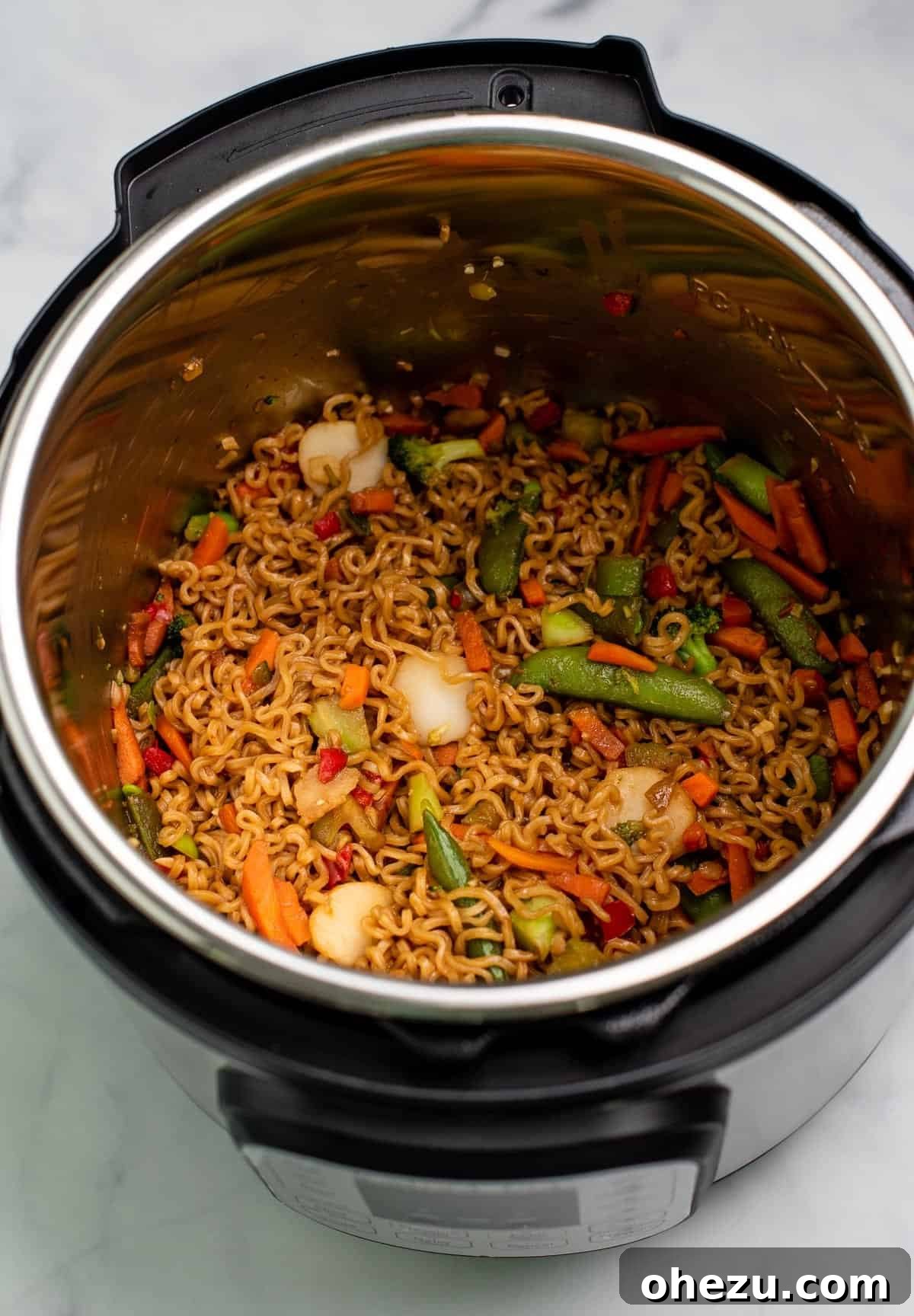 Fully cooked Instant Pot ramen noodle stir fry after opening the lid, ready for final seasoning
