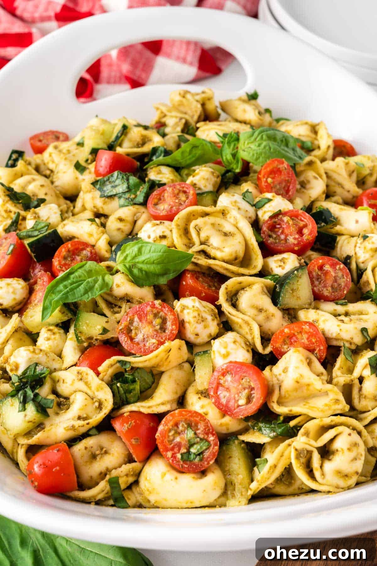 Flavorful Tortellini Pasta Salad 2 tortellini pasta salad in a white serving dish