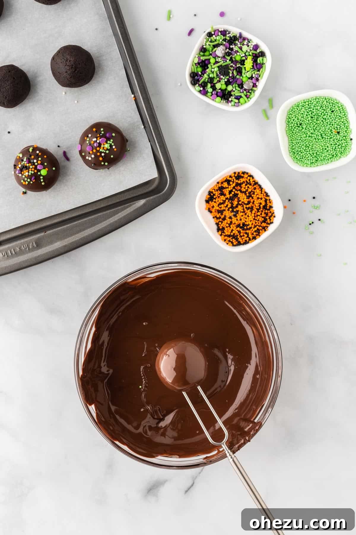 Wicked Oreo Truffles 12 An Oreo ball being dipped into melted dark chocolate