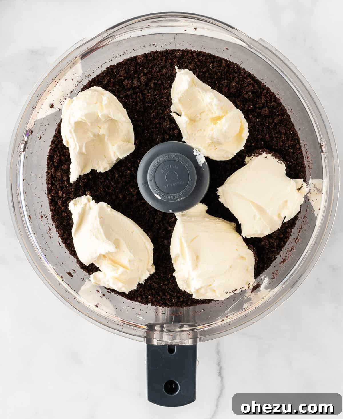 Wicked Oreo Truffles 7 Adding softened cream cheese to crushed Oreos in a food processor
