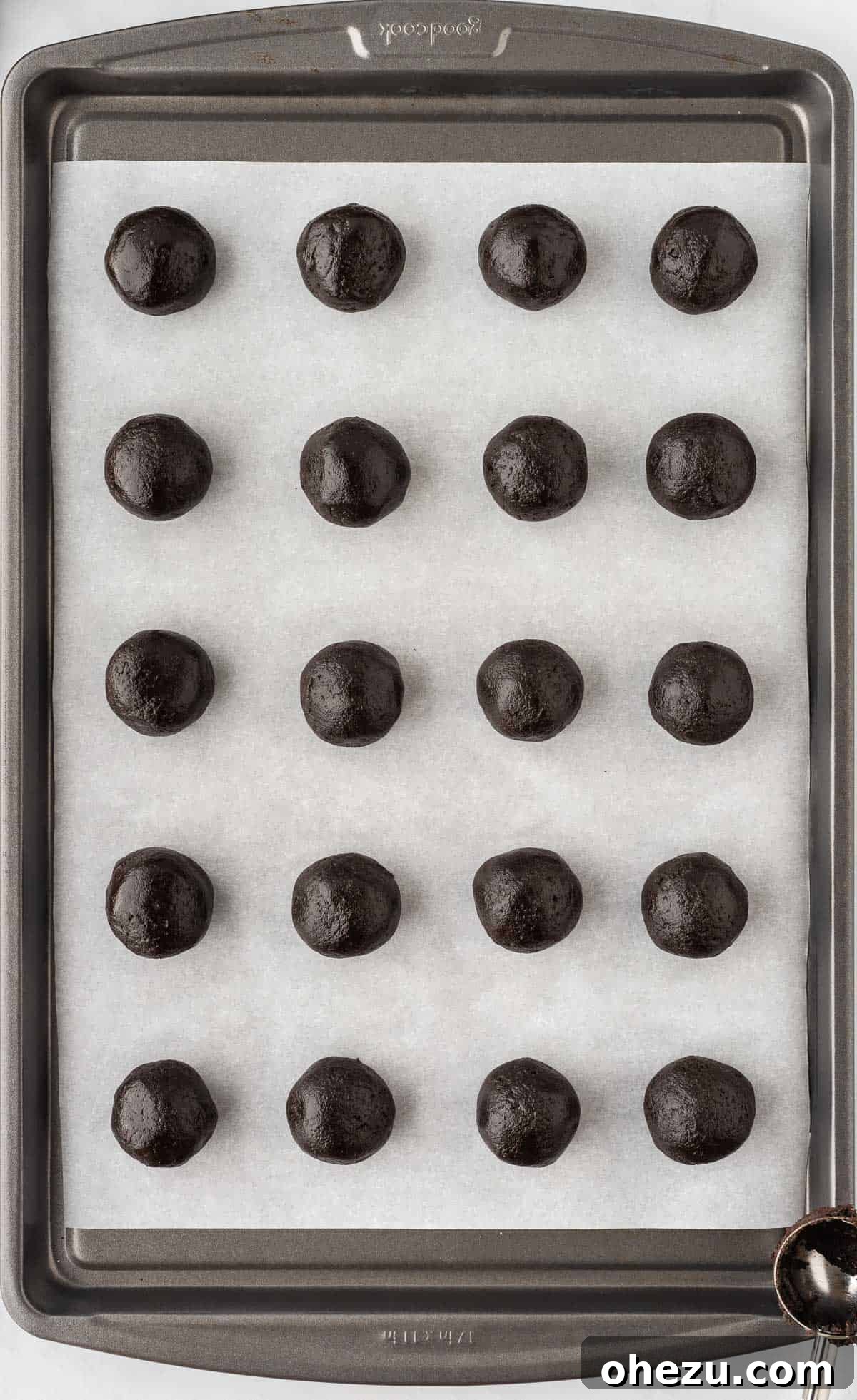 Wicked Oreo Truffles 9 Formed Oreo balls arranged on a parchment-lined baking sheet, ready for chilling