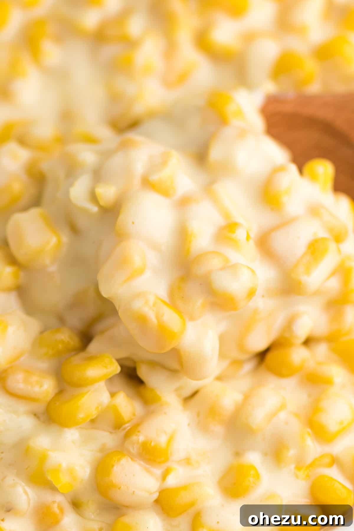 Rich and creamy slow cooker creamed corn in a crock pot, ready to be served, a perfect Southern comfort food side dish.