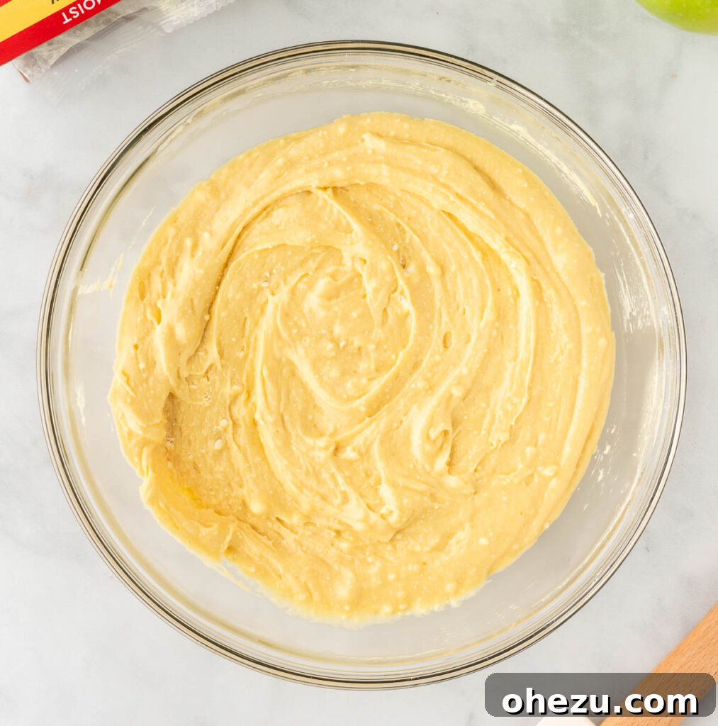The fully mixed cake mix cobbler topping, a thick and creamy batter, showing its smooth consistency.