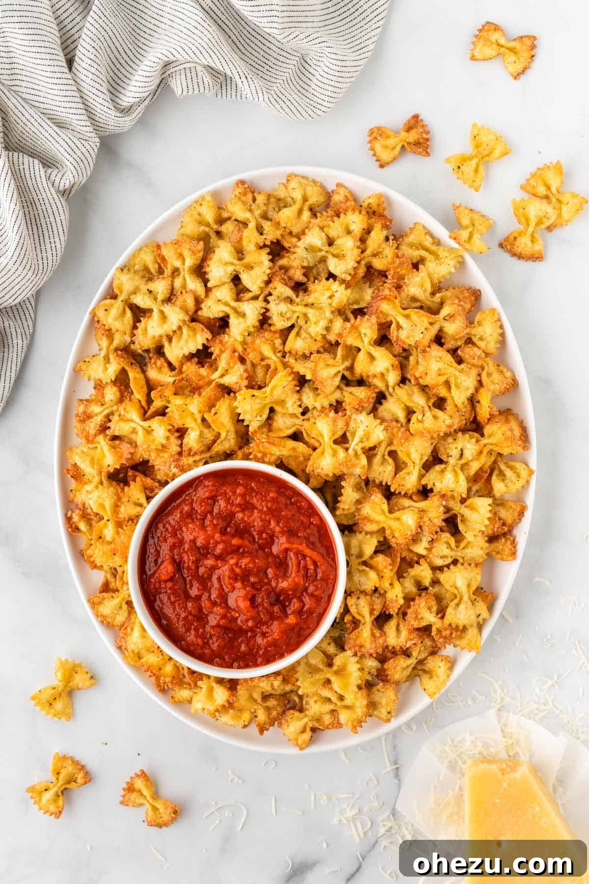 Air fryer pasta chips and a bowl of marinara sauce, ready for dipping