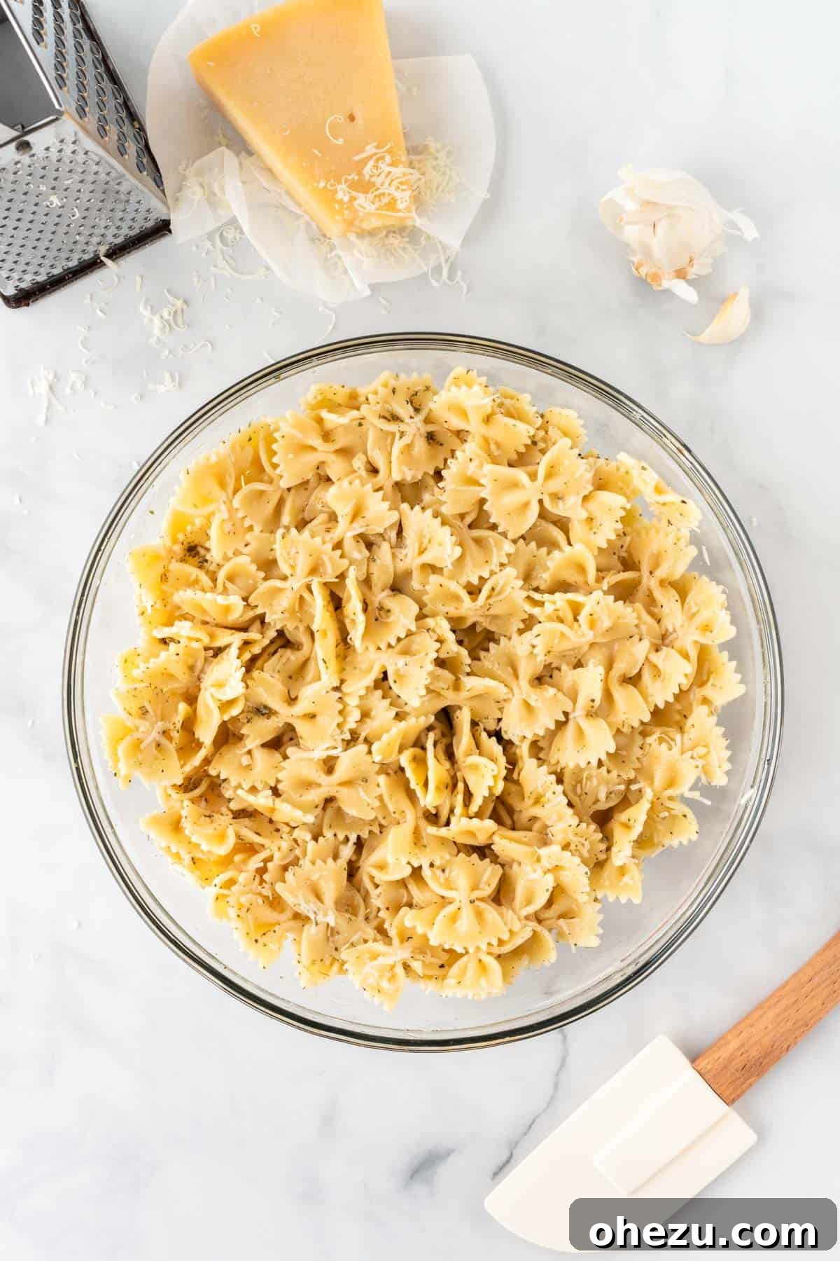Pasta mixed thoroughly with olive oil, spices, and cheese, ready for the air fryer