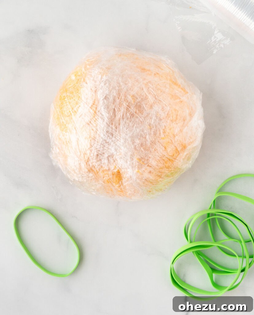 cheese ball wrapped in saran wrap