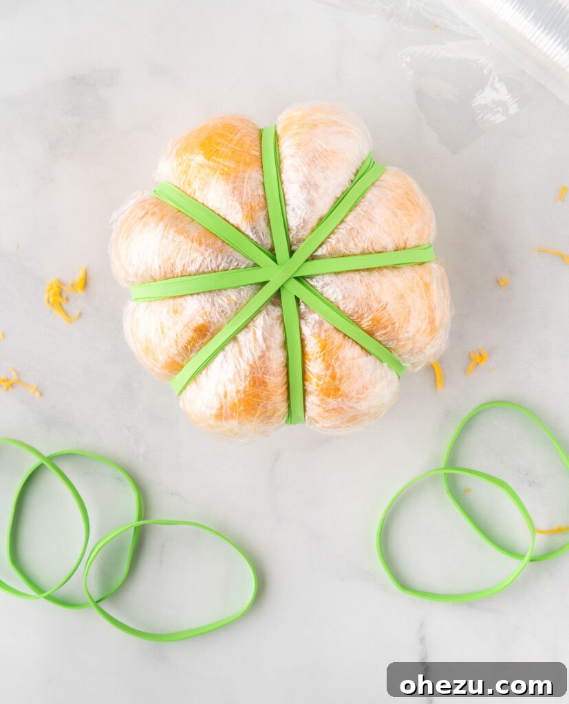 cheese ball shaped with rubber bands to look like a pumpkin