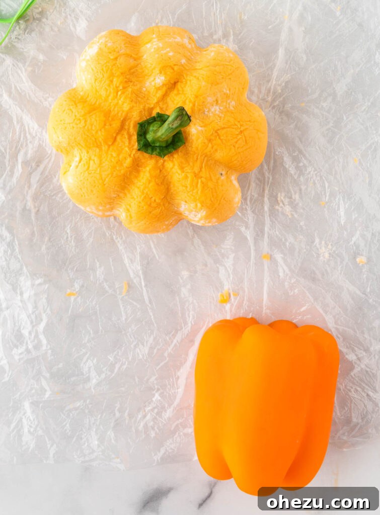 pumpkin shaped cheese ball with a bell pepper stem