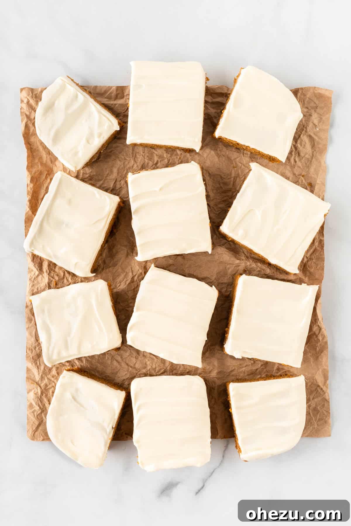 Effortless Fall Spiced Pumpkin Bars 11 A 9x13 inch pan of cake mix pumpkin bars, neatly cut into 12 large squares and topped with cream cheese frosting, ready for serving.