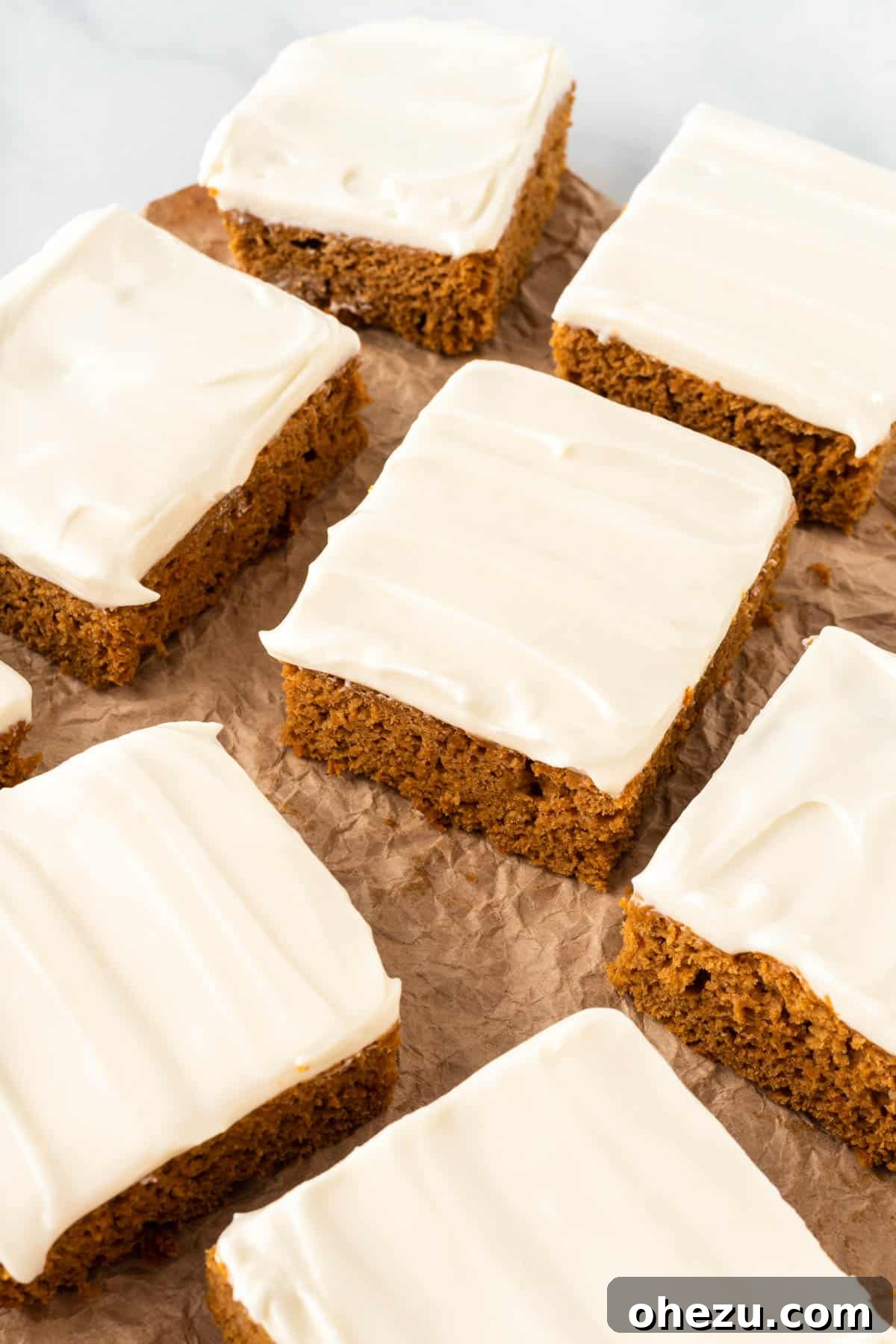 Effortless Fall Spiced Pumpkin Bars 13 Another enticing shot of a single cake mix pumpkin bar with cream cheese frosting, emphasizing its appealing texture and festive presentation.