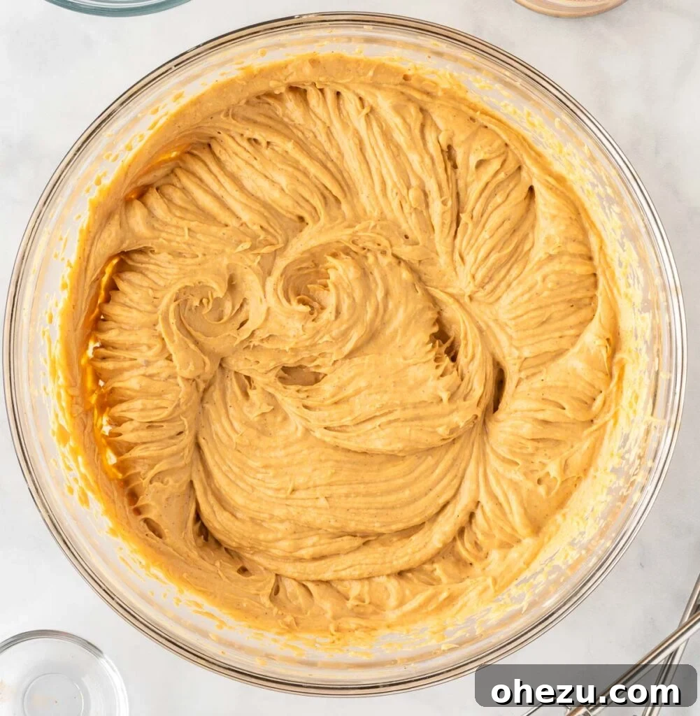 folding whipped cream into the pumpkin cream cheese mixture