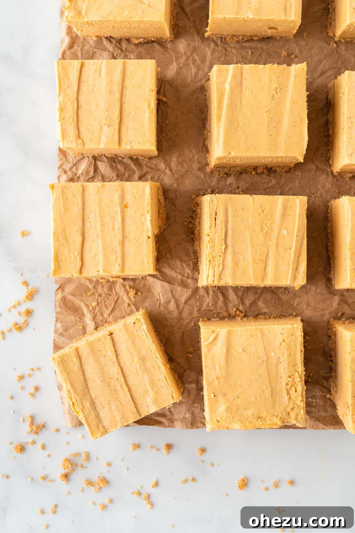 perfectly cut pumpkin cheesecake bars arranged on a platter