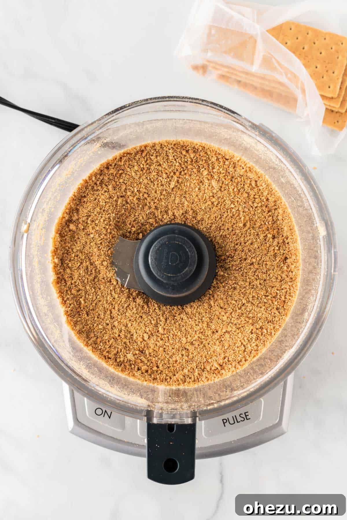finely ground graham cracker crumbs in a food processor bowl