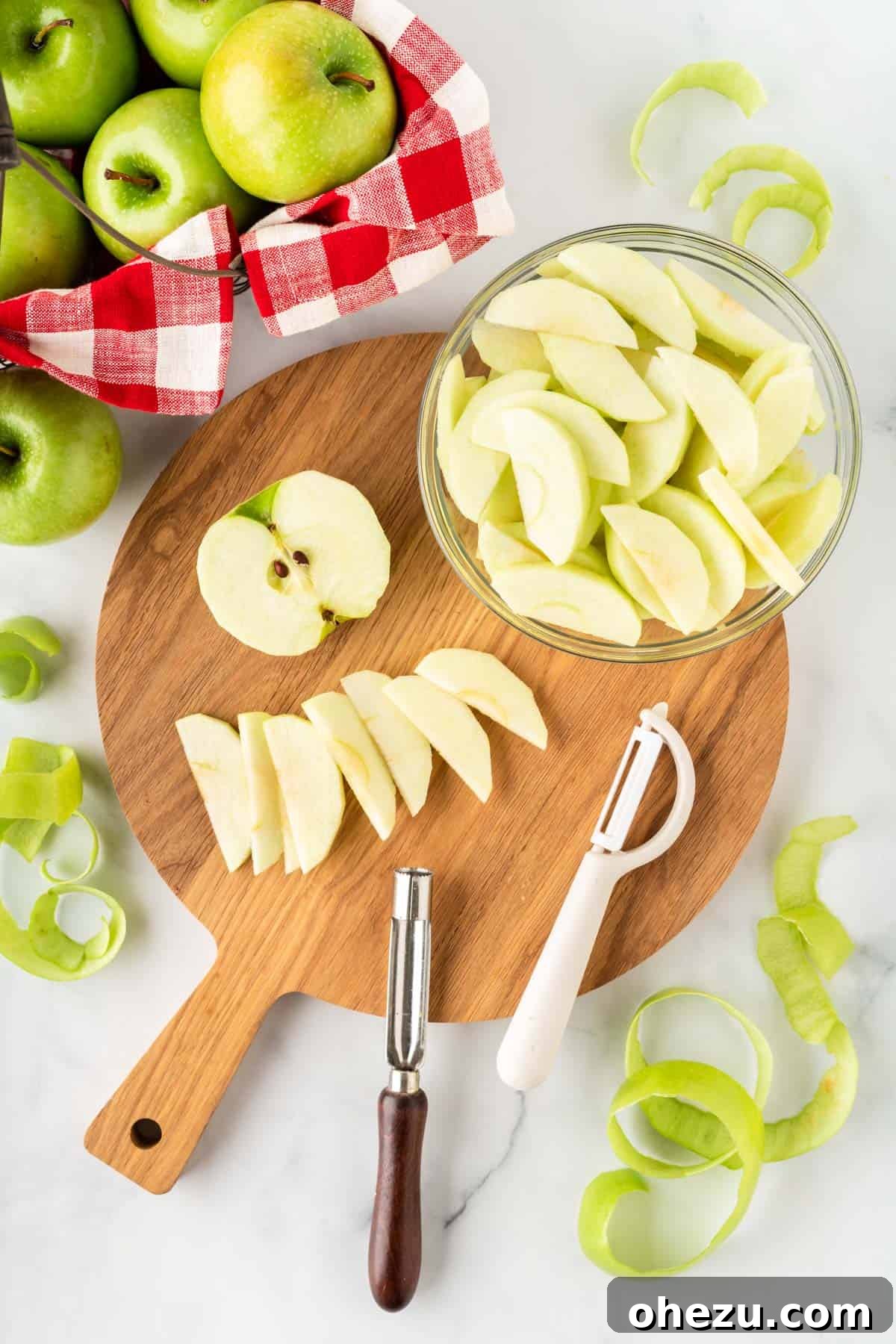 Hands carefully cutting a Granny Smith apple into thin, uniform slices on a cutting board, preparing them for baking.