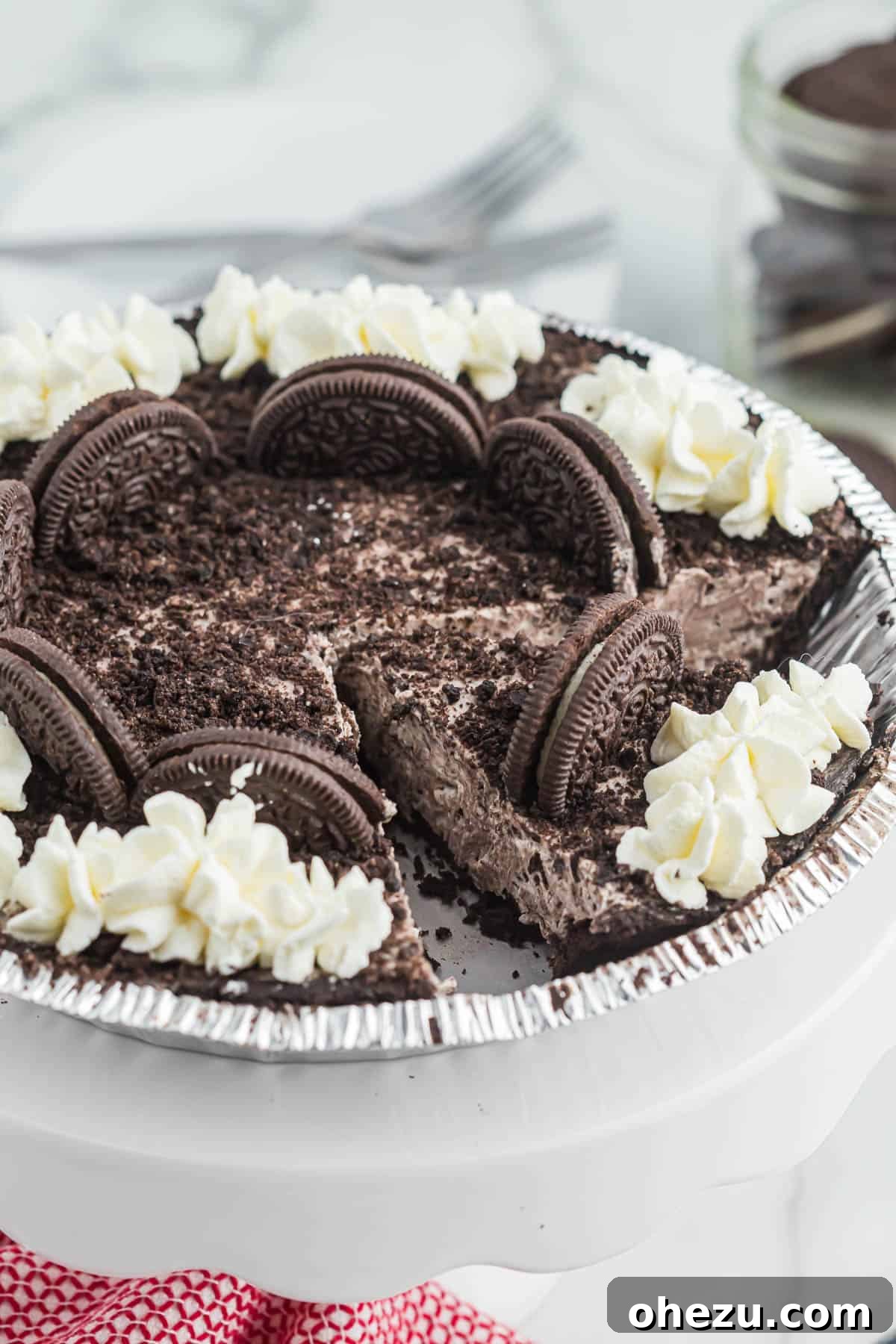 Decadent Oreo Delight 11 A No-Bake Oreo Pie sliced into neat wedges on a cutting board, showcasing the firm, creamy filling and crunchy crust.