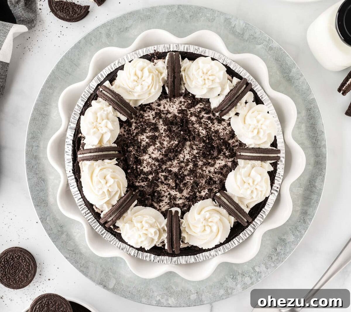 Decadent Oreo Delight 3 A whole, perfectly chilled No-Bake Oreo Pie, ready to be sliced, showcasing its smooth white filling topped with crushed Oreos.