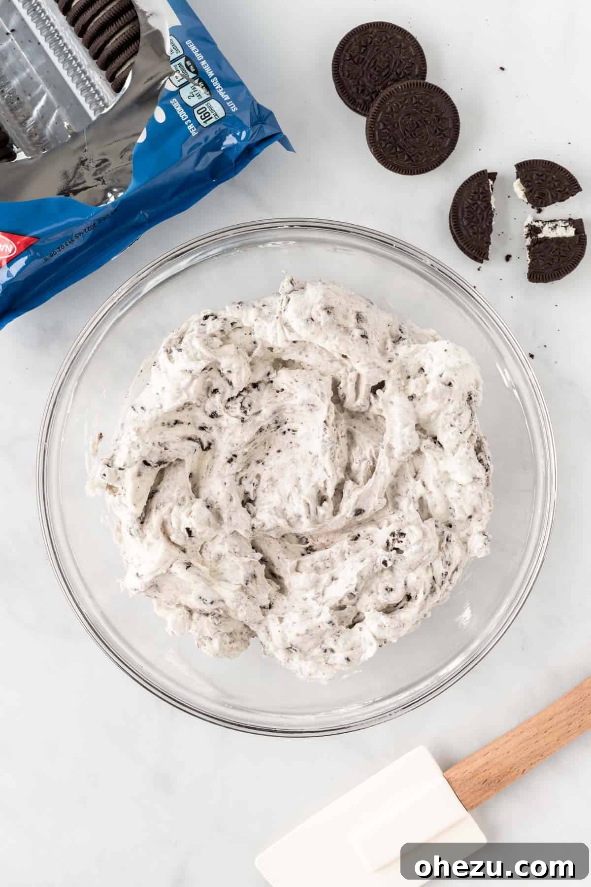 Decadent Oreo Delight 7 The fully mixed Oreo pie filling, a delightful blend of creamy white base and dark crushed cookies, ready to be poured into the crust.