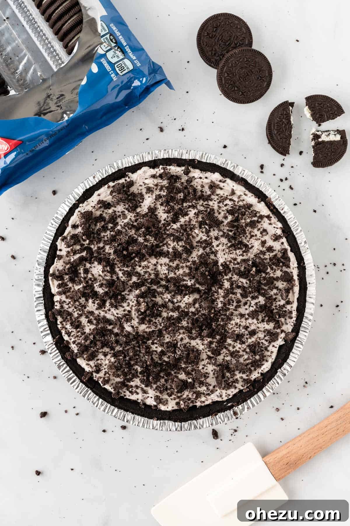 Decadent Oreo Delight 9 The finished No-Bake Oreo Pie, generously topped with the reserved crushed Oreos, creating an appealing crunchy texture.