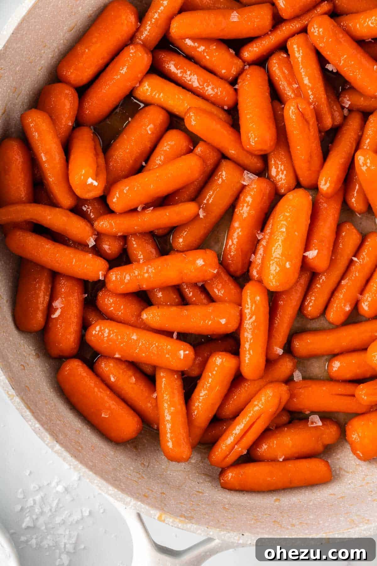 Glistening Honey Brown Sugar Glazed Carrots arranged beautifully in a serving bowl, showcasing their irresistible caramelized coating.