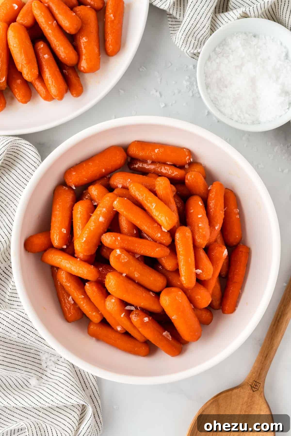 A rustic bowl filled with Honey Brown Sugar Glazed Carrots, highlighting the rich, thick glaze and tender texture.