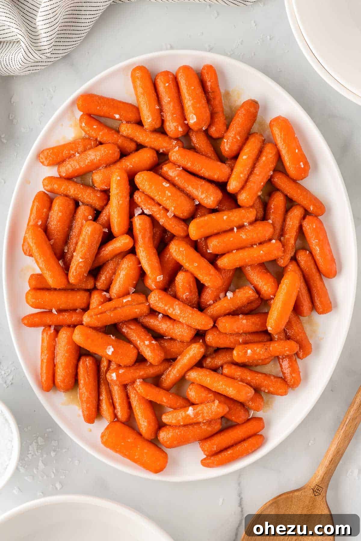 Honey Brown Sugar Glazed Carrots on a sophisticated serving platter, ready to be presented at a dinner party or holiday meal.