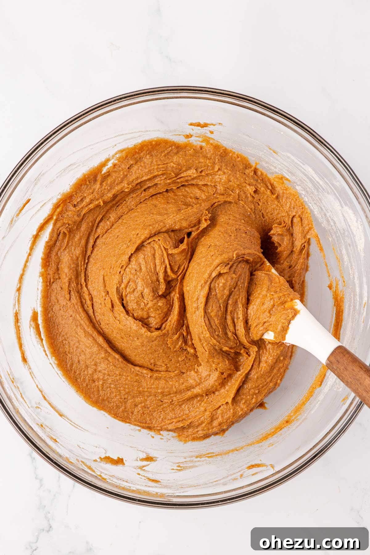 Close-up of the thick cake mix pumpkin cookie batter, perfectly mixed and ready for chocolate chips.