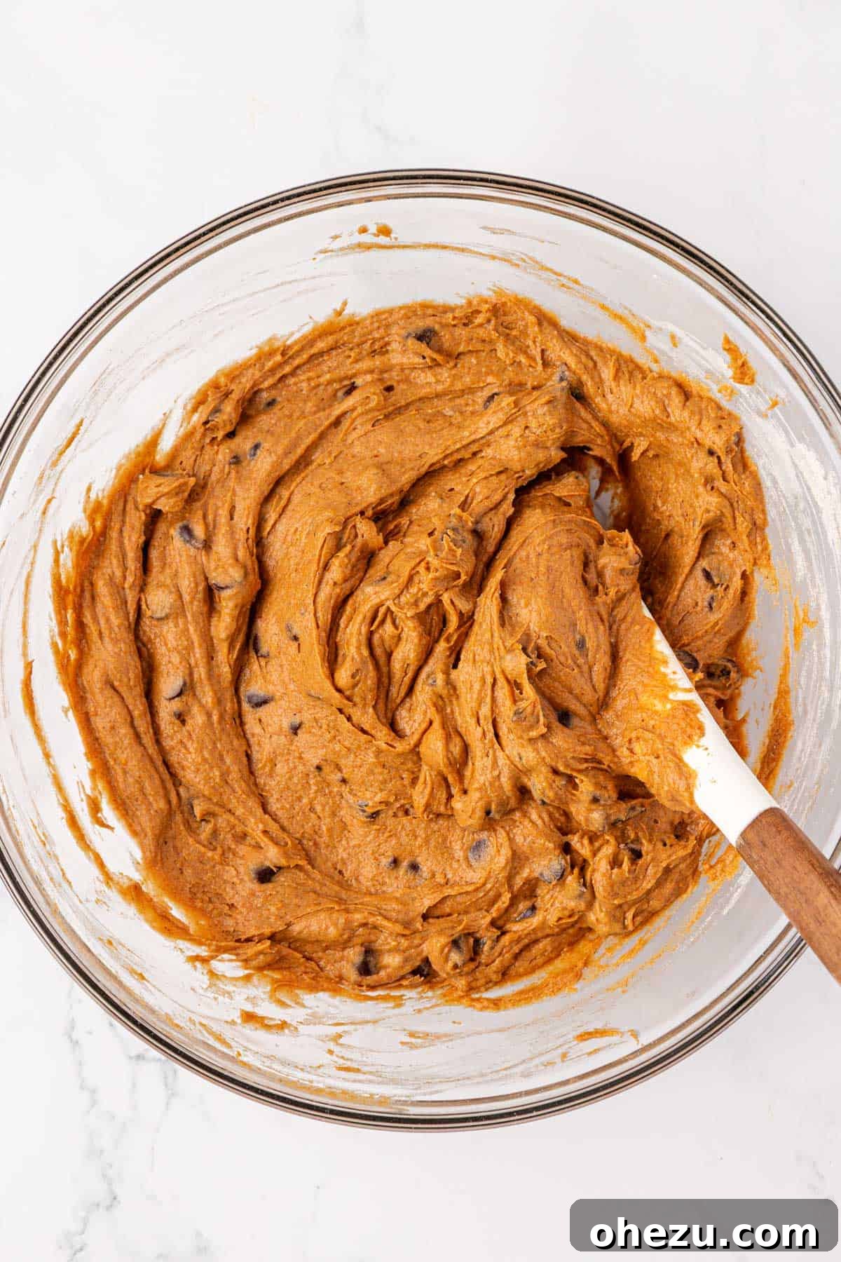 The finished cake mix pumpkin chocolate chip cookie batter, with chocolate chips perfectly folded in, ready for baking.
